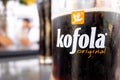 The glass of Czech Kofola beverage which resembles various cola drinks