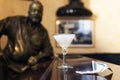 Glass of Daiquiri cocktail and statue of American writer Ernest Hemingway in the bar El Floridita in Havanna