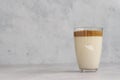 Glass with Dalgona frothy coffee. Trend korean drink with coffee foam. Royalty Free Stock Photo