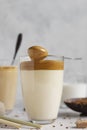 Glass with Dalgona frothy coffee. Trend korean drink with coffee foam. Royalty Free Stock Photo