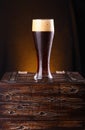 Glass of dark beer on a chest