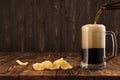 Glass with a dark beer on a wooden table Royalty Free Stock Photo