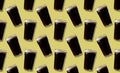 Glass of dark beer on a yellow background pattern