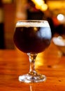 Glass of dark Belgian beer. Royalty Free Stock Photo