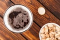 glass of dark cold frothy beer, nuts, bottle cap, old wooden tab Royalty Free Stock Photo