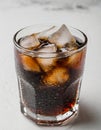 Glass of dark fizzy drink with ice cubes, cola or soda beverage on light background, summer refreshment cocktail Royalty Free Stock Photo