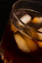 Glass with dark liquid full with ice cubes Royalty Free Stock Photo