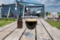 Glass of dark strong belgian beer served on outdoor terrace with green grass meadow on background Royalty Free Stock Photo