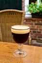 Glass of dark tasty Belgian dubbel brown beer from abbey brewery Royalty Free Stock Photo