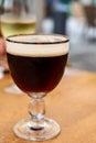 Glass of dark tasty Belgian dubbel brown beer from abbey brewery Royalty Free Stock Photo