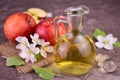 Glass decanter with apple cider vinegar and fresh apples on gray background.