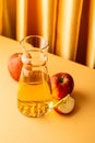 Glass decanter with apple juice and ripe apples