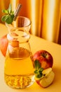 Glass decanter with apple juice and ripe apples