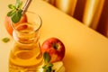 Glass decanter with apple juice and ripe apples