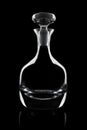Glass decanter on the black background.