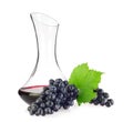 Glass decanter with red organic wine and blue grapes