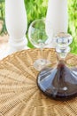Glass Decanter with Red Wine on Rattan Wicker Table in Garden Terrace of Villa or Mansion. Authentic Lifestyle Image. Gourmet Royalty Free Stock Photo
