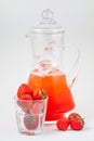 Glass decanter with strawberry juice and ice