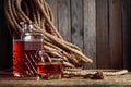 Glass and decanter with strong alcohol on a old wooden background Royalty Free Stock Photo