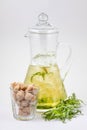 Glass decanter with tarragon juice and ice
