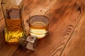 A glass and a decanter with whiskey stand on a wooden table Royalty Free Stock Photo