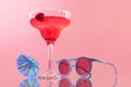 Glass of delicious alcohol drink, strawberry margarita cocktail isolated over pink background. Summertime party. Royalty Free Stock Photo