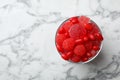 Glass of delicious chewing candies on marble table