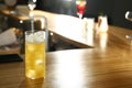 Glass of delicious cocktail with vodka on wooden counter in bar Royalty Free Stock Photo
