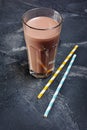 Glass of delicious cold chocolate milk with cocktail straw Royalty Free Stock Photo