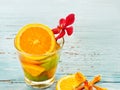 Glass delicious refreshing drink of mix fruits orange and lemon on blue wooden, infusion water Royalty Free Stock Photo