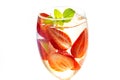 Glass delicious refreshing drink of strawberry with mint on white background