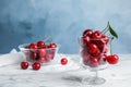 Glass dessert bowl with ripe sweet cherries on marble table Royalty Free Stock Photo