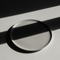 The glass disc casts a subtle shadow adding depth to the composition Royalty Free Stock Photo
