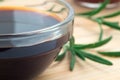 Glass dish with soy sauce and rosemary sprigs Royalty Free Stock Photo