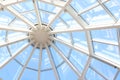 Glass dome with white structure in shopping mall in sunny day