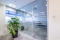 Glass door and green plant in office Royalty Free Stock Photo
