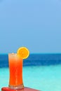 Glass of drink is on a beach table Royalty Free Stock Photo