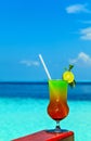 Glass of drink is on a beach table Royalty Free Stock Photo