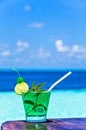 Glass of drink is on a beach table Royalty Free Stock Photo