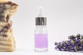 A glass dropper bottle and lavender soap on the grey background Royalty Free Stock Photo