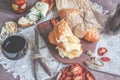 A glass of dry red wine and Italian Focaccia bread with cheese and olive oil and sun dried tomatoes. Selective focus. The Royalty Free Stock Photo