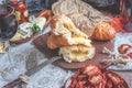 A glass of dry red wine and Italian Focaccia bread with cheese and olive oil and sun dried tomatoes. Selective focus. The Royalty Free Stock Photo