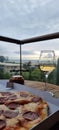 A glass of dry white wine and pepperoni pizza on the balcony Royalty Free Stock Photo