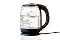 Glass electric kettle with boiling water on a white insulated background Royalty Free Stock Photo