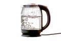 Glass electric kettle with boiling water on a white insulated background Royalty Free Stock Photo