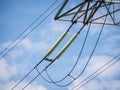 Glass electrical insulators on high voltage power line tower. Close-up Royalty Free Stock Photo