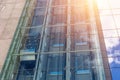 Glass elevators outside the skyscraper building, business architecture