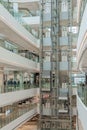 Glass Elevators in White Retail Interior Design. Shopping Mall LuOne Shanghai