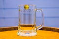 Glass empty beer glass stands on beer barrel Royalty Free Stock Photo