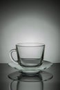 Glass empty mug of tea and saucer on a black and white background Royalty Free Stock Photo